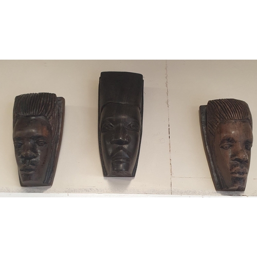 55 - A good quantity of Hardwood figural African Heads.