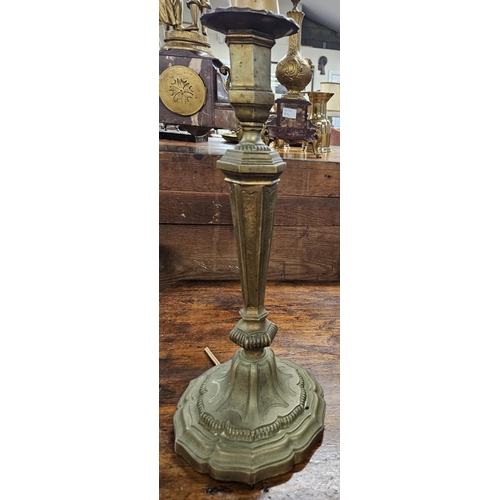 229 - An extremely heavy single Brass Candlestick. H 44 cm approx.