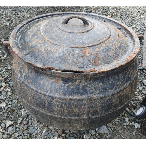 1410 - An extremely large cast Iron Skillet with lid, damage to the lid. H 48 x D 52 cm approx.