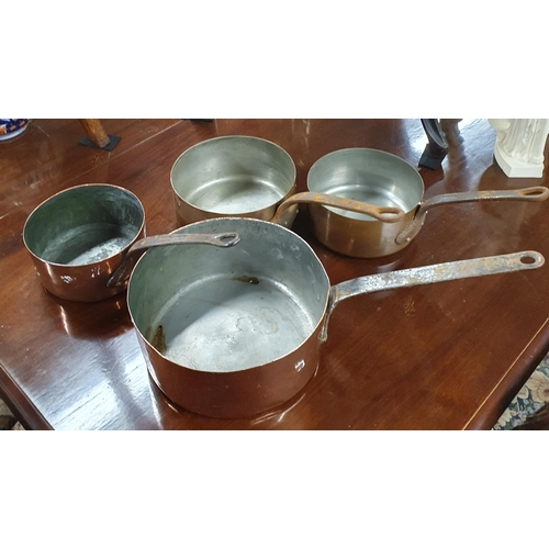 235 - A heavy graduated set of Copper Saucepans with cast iron handles. 
Smallest H 9 x D 15 and Largest H... 