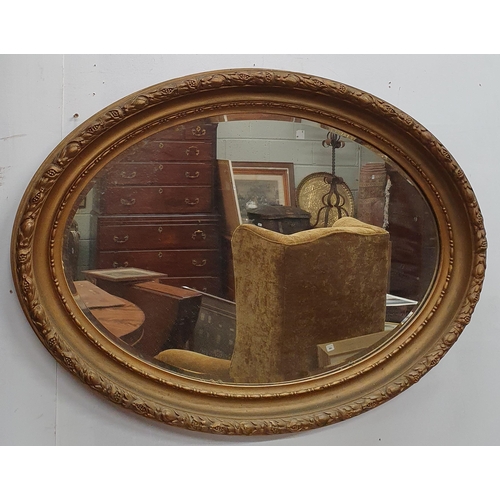 19 - A 19th Century Plaster and timber gilt oval Mirror with bevelled glass. 67 x 90 cm approx.