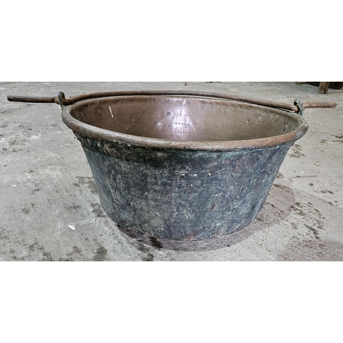 302 - An extremely large Copper Cauldron with cast Iron handle. D 61 x H 31 cm approx.