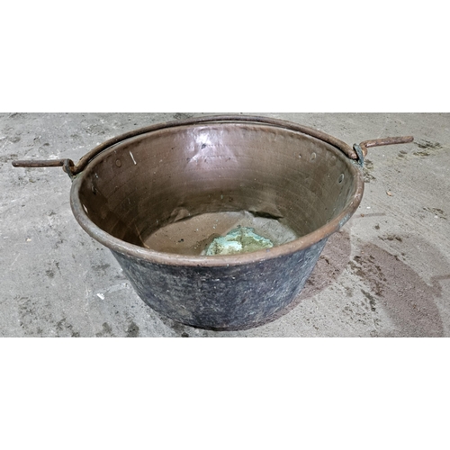 302 - An extremely large Copper Cauldron with cast Iron handle. D 61 x H 31 cm approx.