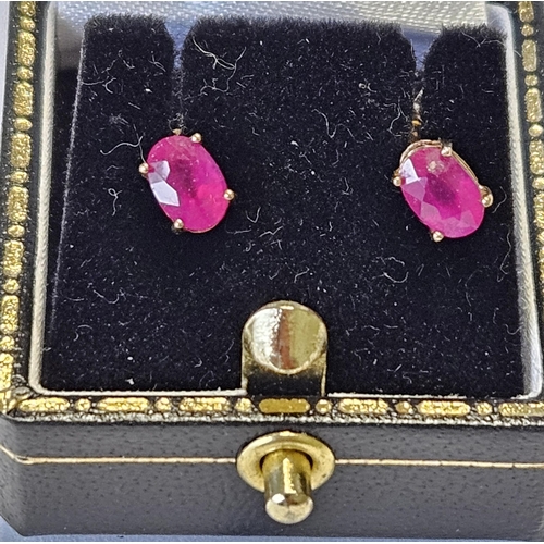 393 - A pair of 9ct Gold and Ruby Earrings.