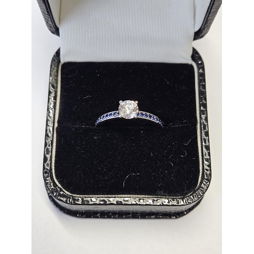 381 - An 18ct Gold, Diamond solitaire Ring, Diamond approx .8ct set with Sapphires on the band, size N1/2.