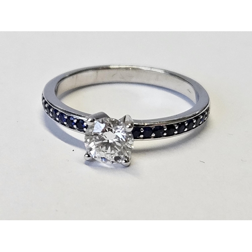 381 - An 18ct Gold, Diamond solitaire Ring, Diamond approx .8ct set with Sapphires on the band, size N1/2.