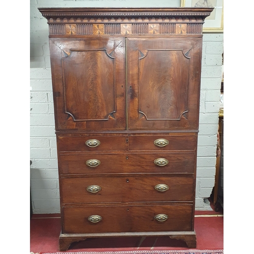 9 - An early 19th Century Mahogany Gentleman's Cupboard with shirt drawer interior top and secretaire ce... 