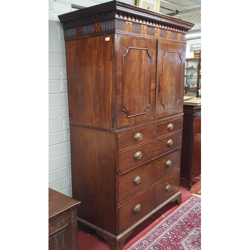 9 - An early 19th Century Mahogany Gentleman's Cupboard with shirt drawer interior top and secretaire ce... 