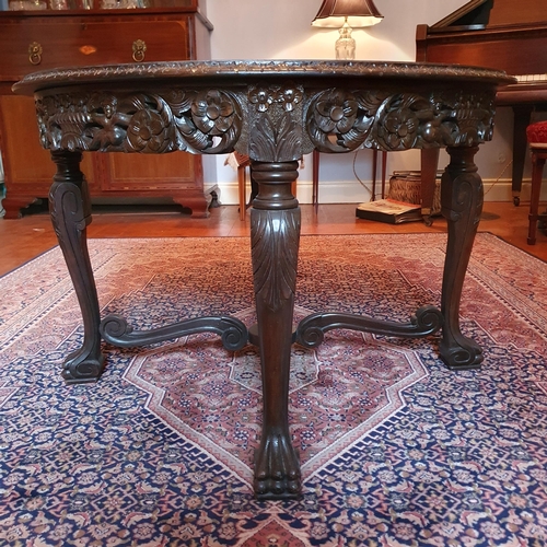 262 - An early 20th Century Walnut circular Centre Table with tray top and highly carved pierced outline. ... 