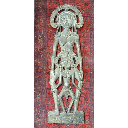 114 - A large hand carved South American Plaque depicting two females and a child with headdress.
H 96 x W... 