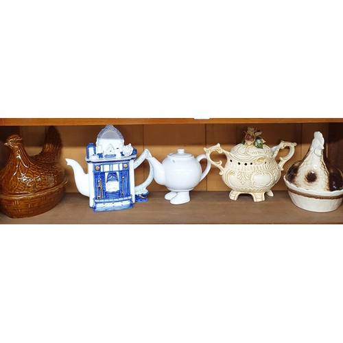 146 - A good quantity of Collectibles, teapots, egg crocks etc. on one shelf.