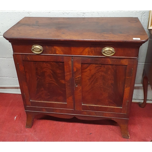 161 - An early 19th Century Mahogany two door Cabinet with single frieze drawer and flame grain panel door... 