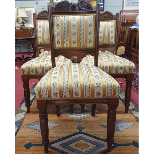 254 - A Set of Six Edwardian Walnut Chairs with highly carved and upholstered backs and seats, on turned s... 