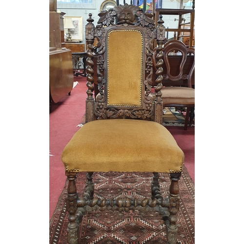 273 - A good pair of 19th Century Oak Hall Chairs with highly carved mask head and upholstered backs on tu... 