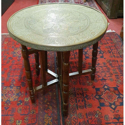 512 - A 20th Century fold up Table with brass top. H 47 x D 45 cm approx.