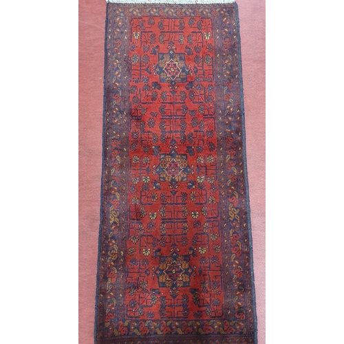 539 - Of Exceptional quality. A Red ground full pile hand woven Tubi double Knotted Runner.  141 x 59 cm a... 