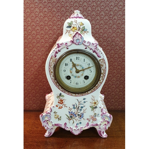 569 - An early 20th Century Bracket Clock with floral outline. H 29 cm approx.