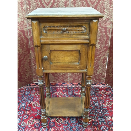 576 - A 19th Century Walnut marble top side Cabinet with single frieze drawer and door on turned fluted su... 