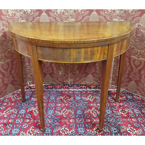 703 - A Regency Mahogany Foldover Card Table with crossbanded inlaid top and frieze and square tapered sup... 