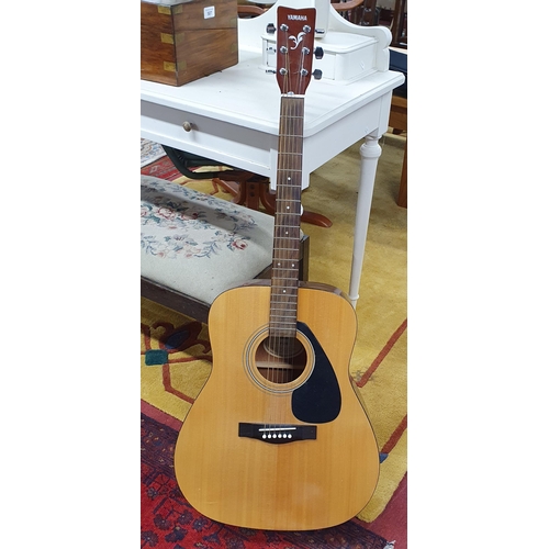 511 - A Yamaha F310 acoustic Guitar in a carry case. L 104 cm approx. Along with a Soligor Phot and Video ... 