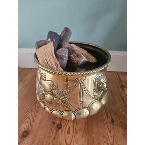 305 - A good Brass embossed Log Bin with lions head ring handles.