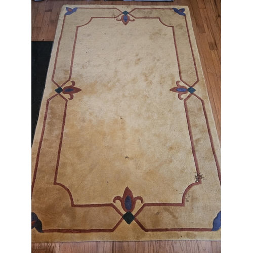 509 - A mustard colour Carpet with Fleur-de-lis style design. L 240 x W 150 cm approx.