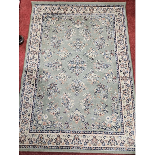 261 - A green ground Carpet with repeating central design.
169 x 120 cm approx.