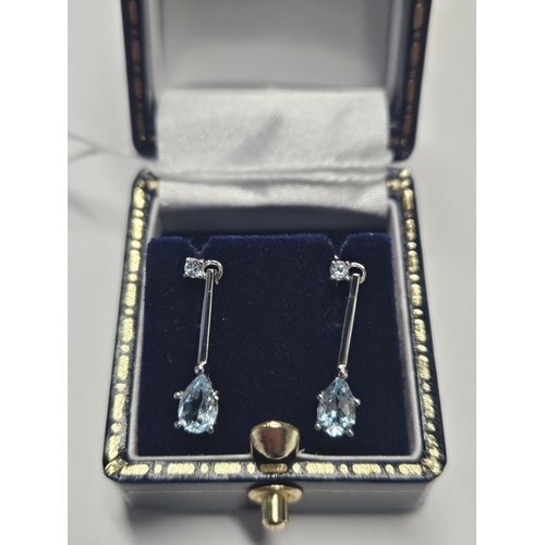 403 - A pair of White Gold and Aquamarine drop Earrings.