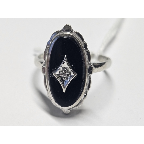 404 - A White Gold, Onyx and Diamond Ring, size P1/2.