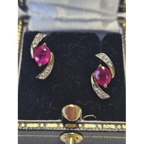 424 - A pair of Gold, Diamond and Ruby Earrings.