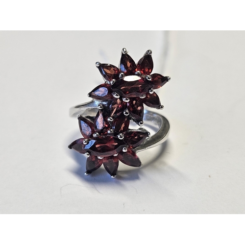 425 - A Silver and Garnet set cluster Ring, size O.