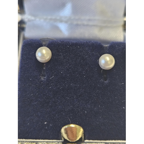 427 - A pair of 9ct Gold and Pearl ball Earrings.