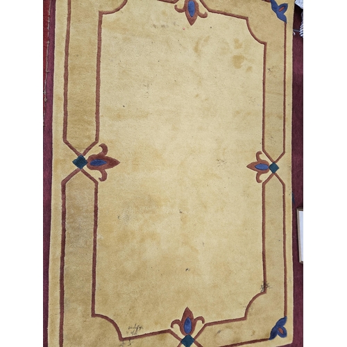 509 - A mustard colour Carpet with Fleur-de-lis style design. L 240 x W 150 cm approx.