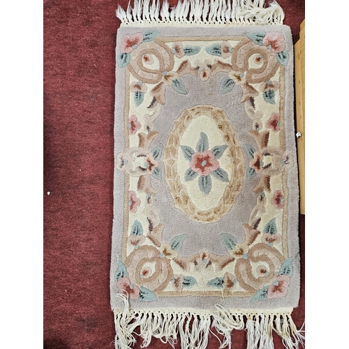 524 - An Oriental pink ground Rug.
L 82 x W 48 cm approx.