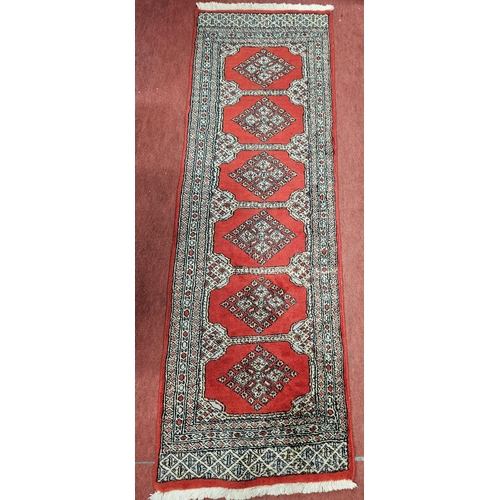 546 - Of Exceptional quality, a Red ground super fine Pakistan hand woven runner with a Jilda design. L 19... 