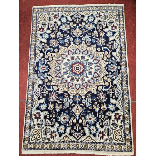 547 - A Rich Blue ground fine hand woven Persian Nian wool part silk Rug with a lozenge medallion design, ... 