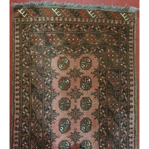 687 - A good burgundy ground Persian Runner with repeating central medallion design. 284 x 79cm approx.