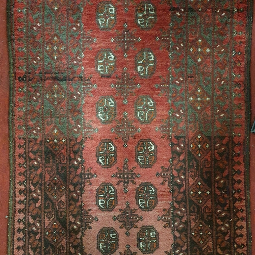 687 - A good burgundy ground Persian Runner with repeating central medallion design. 284 x 79cm approx.