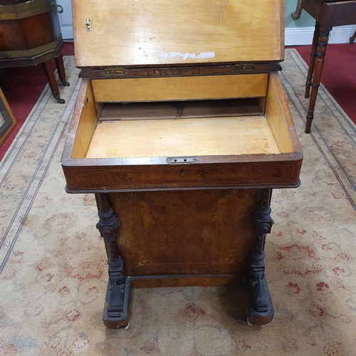 1093 - A 19th Century Walnut and Burr Walnut Davenport with lift up lid on carved front supports. 53 x D 49... 