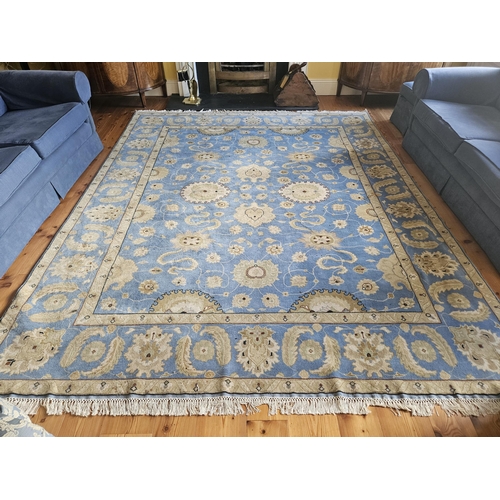 372 - A blue ground Carpet with repeating central medallion design and multi borders. From the living room... 