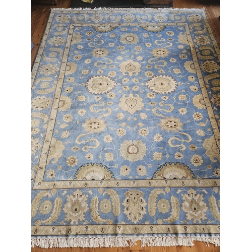 372 - A blue ground Carpet with repeating central medallion design and multi borders. From the living room... 