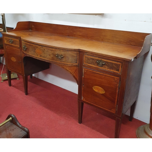 928 - An early 19th Century Mahogany and Veneered Sideboard with bow front and gallery back on square tape... 