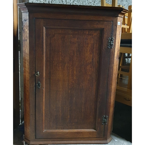 1016 - A 19th Century Oak wall mounted corner cupboard.