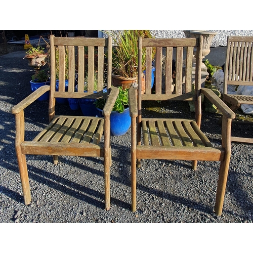 1070 - A pair of Teak garden Armchairs along with seat cushions.
 BH 100 x W 60 x D 60 cm approx.