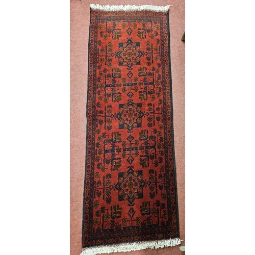 956 - Of Exceptional quality. A Red ground full pile hand woven Tubi double Knotted Runner. L 1585 x W 53 ... 