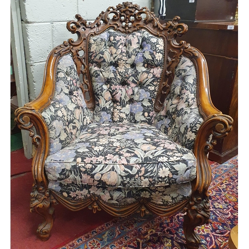 922 - A pair of highly carved easy Armchairs with deep buttoned backs. W 85 x SH 44 x BH 100 cm approx.