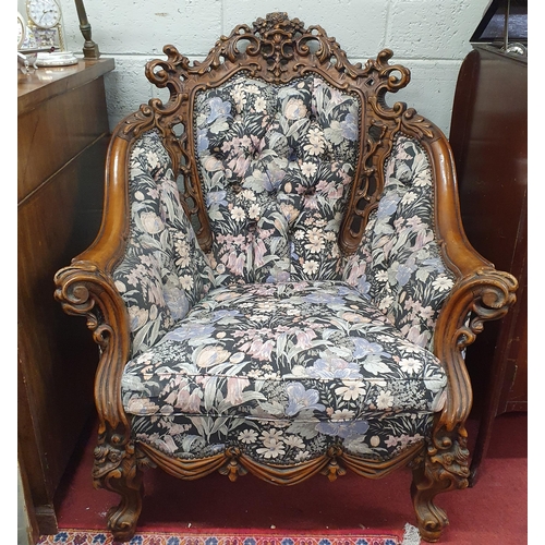 922 - A pair of highly carved easy Armchairs with deep buttoned backs. W 85 x SH 44 x BH 100 cm approx.