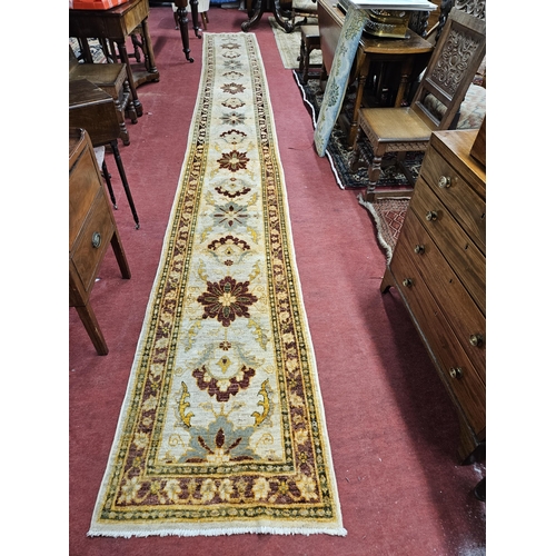 546 - A large long Afghan Cream Ground Runner with Beige ground multi borders and repeating central design... 