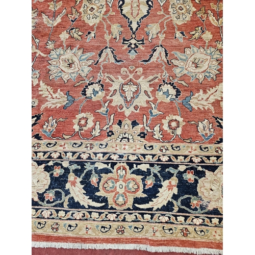 564 - A large Beige Ground Persian Carpet with unique centre medallion design and multi borders 436 cm x 3... 