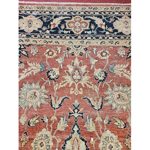 564 - A large Beige Ground Persian Carpet with unique centre medallion design and multi borders 436 cm x 3... 